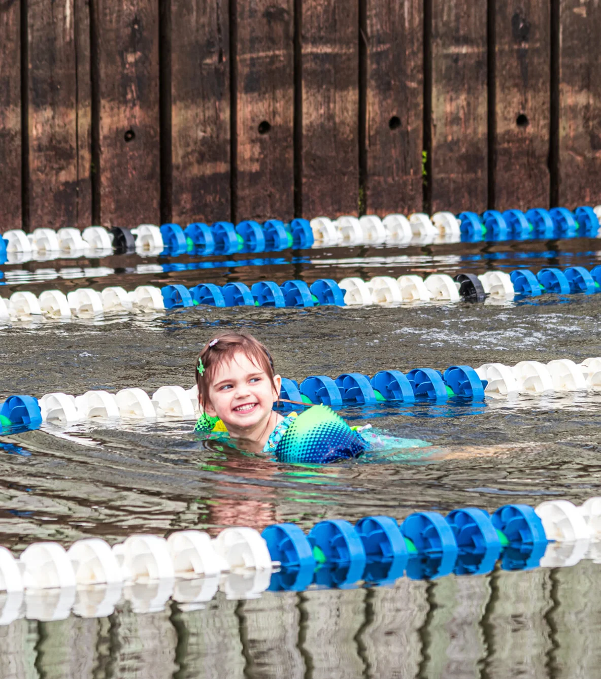 Child smilling in a pool