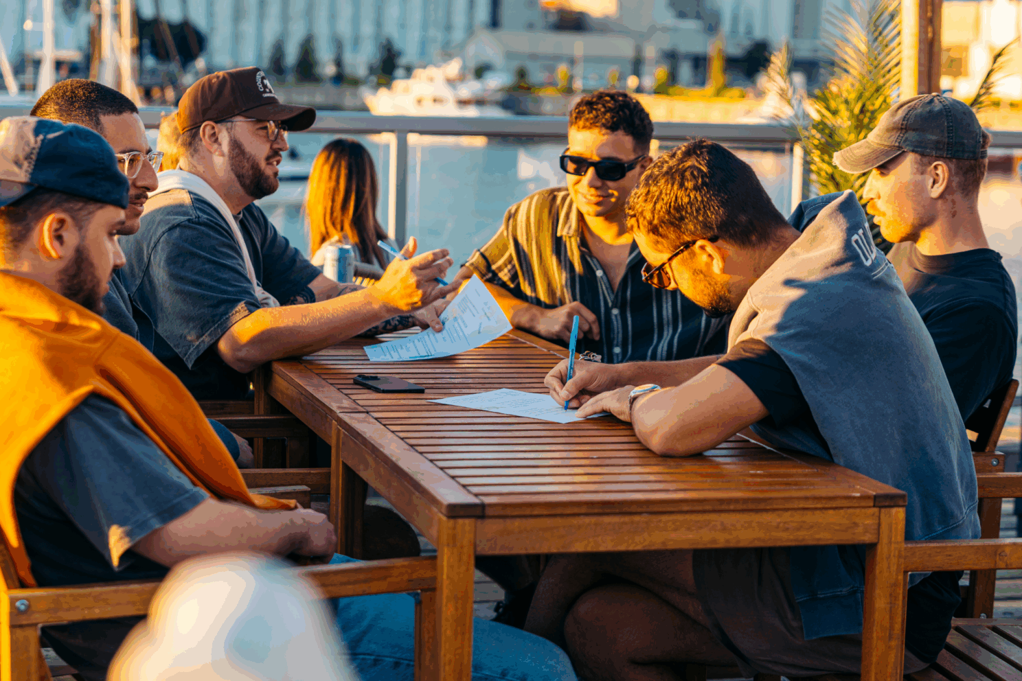 Quatre garçons sur la terrasse de l'oasis en train de remplir une feuille de quiz